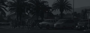 Black and White image of pedestrians crossing a street with a crossing guard